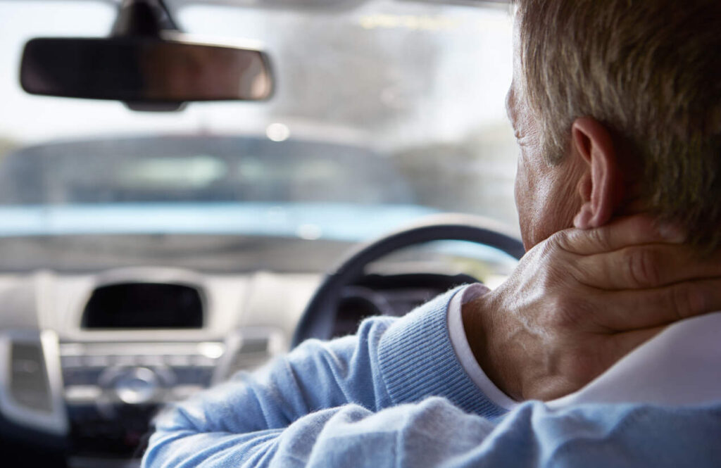 Whiplash during the car driving accident , man holding neck due to pain 