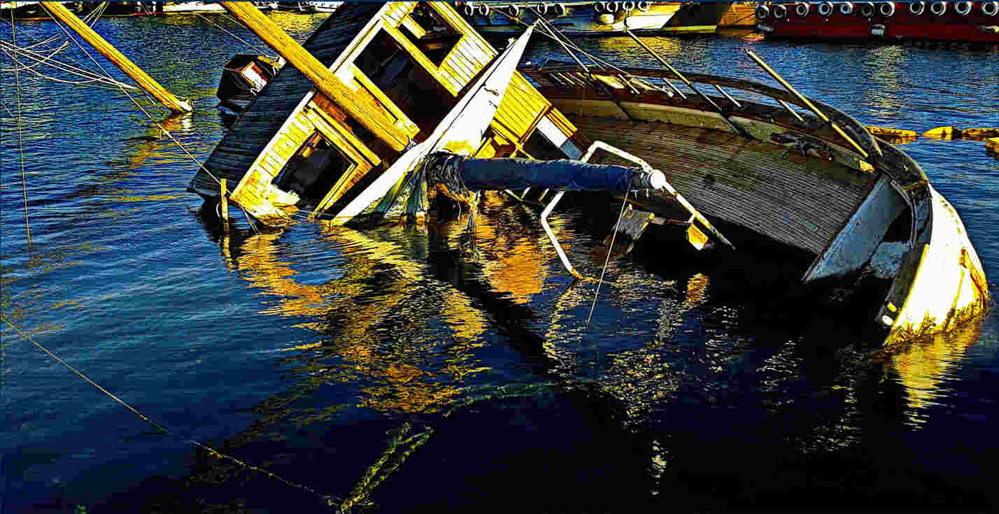 Sinking wooden boat after a boating accident in South Carolina harbor, highlighting risks and fatalities on the water.